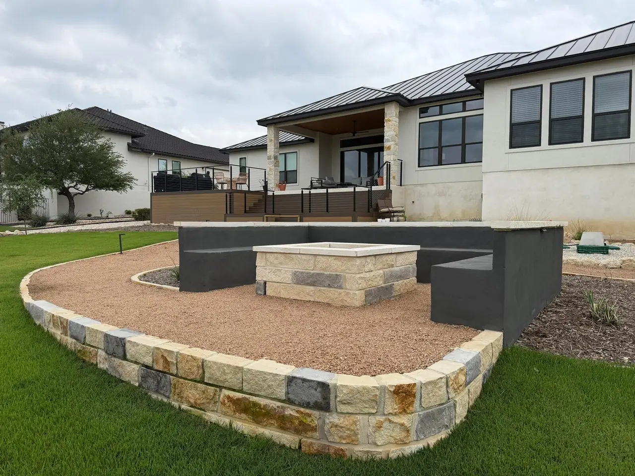 Custom fire pit with limestone seating wall