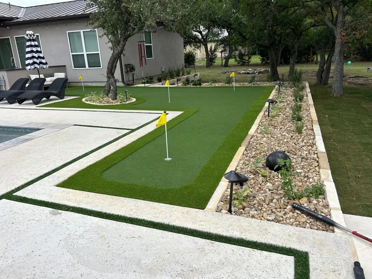 Custom backyard putting green with flags